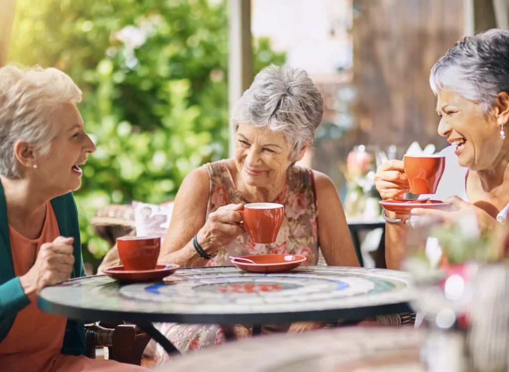 Hearing aids help woman talking to friends Hearing aids helps woman talking to friends