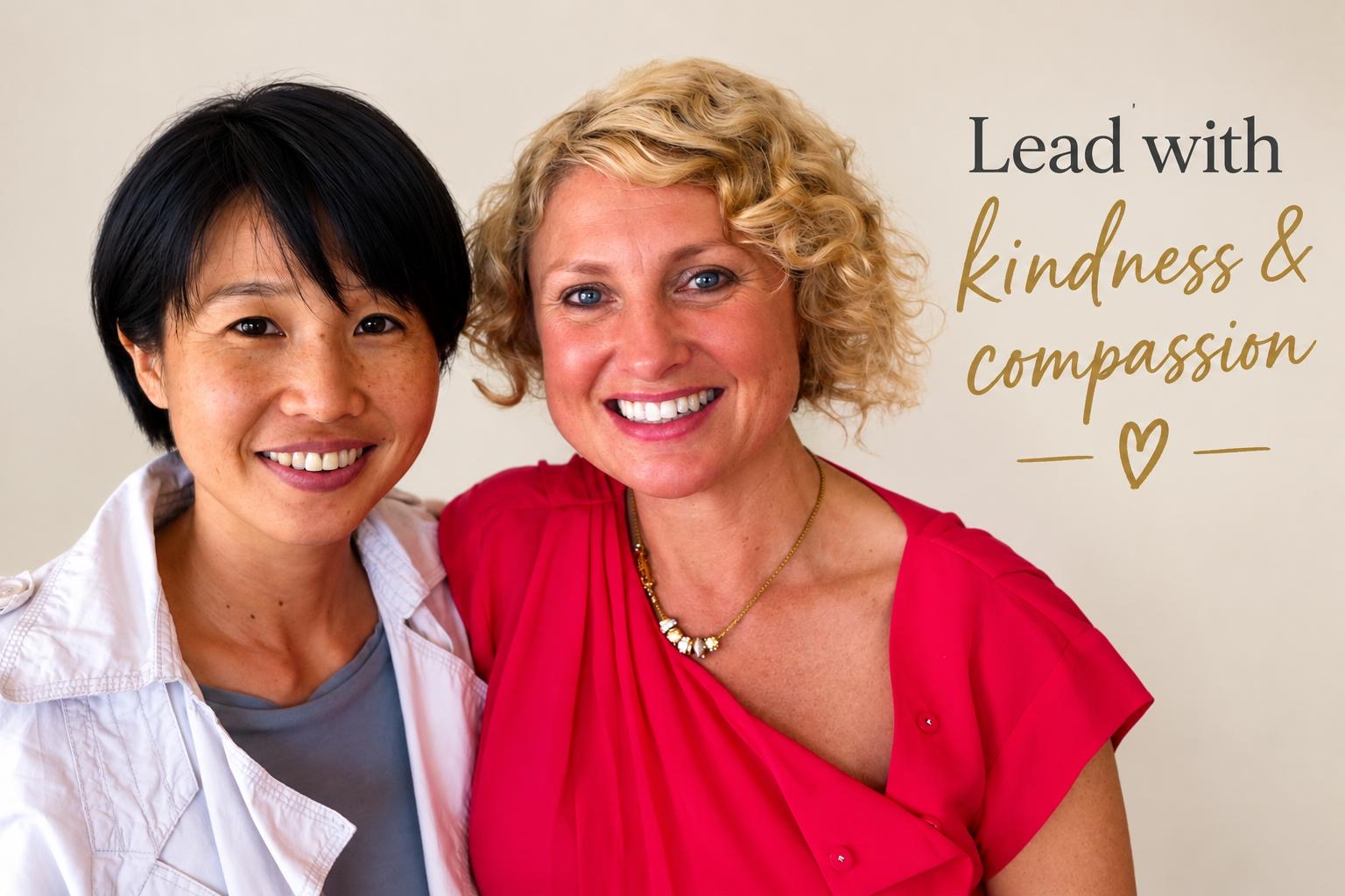 Two women smiling, one with short black hair wearing a light grey jacket over a grey shirt, and another with curly blonde hair wearing a bright pink top and a gold necklace. Text overlay reads "Lead with kindness & compassion" with a heart icon.