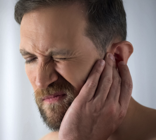 sudden hearing loss in one ear. man touching ear, concerned look on face